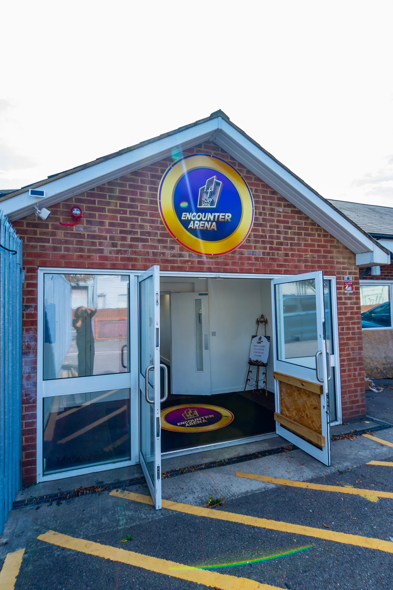 Open church entrance with the Encounter Arena sign above