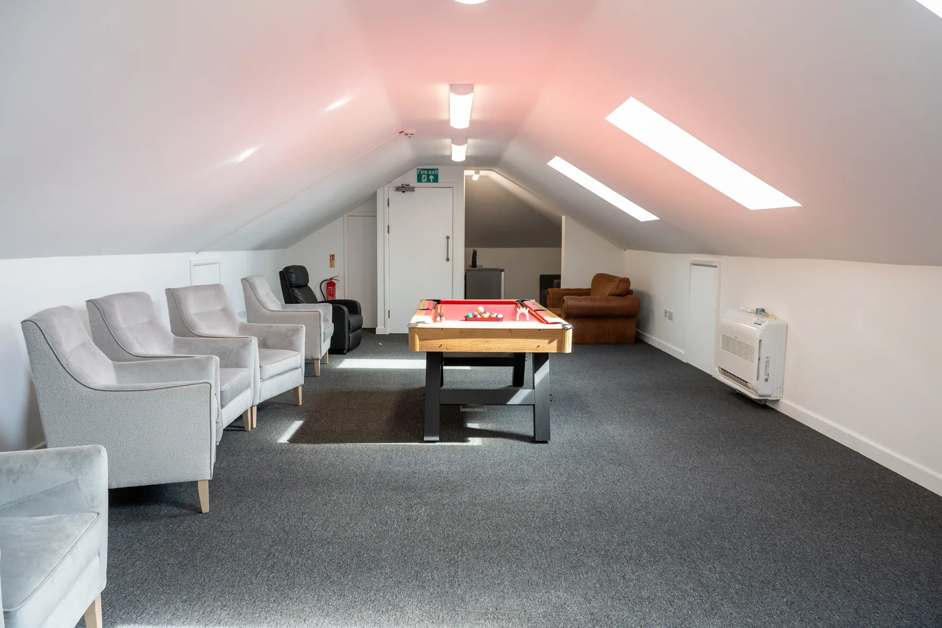 A seating area with sofas and a table inside the church