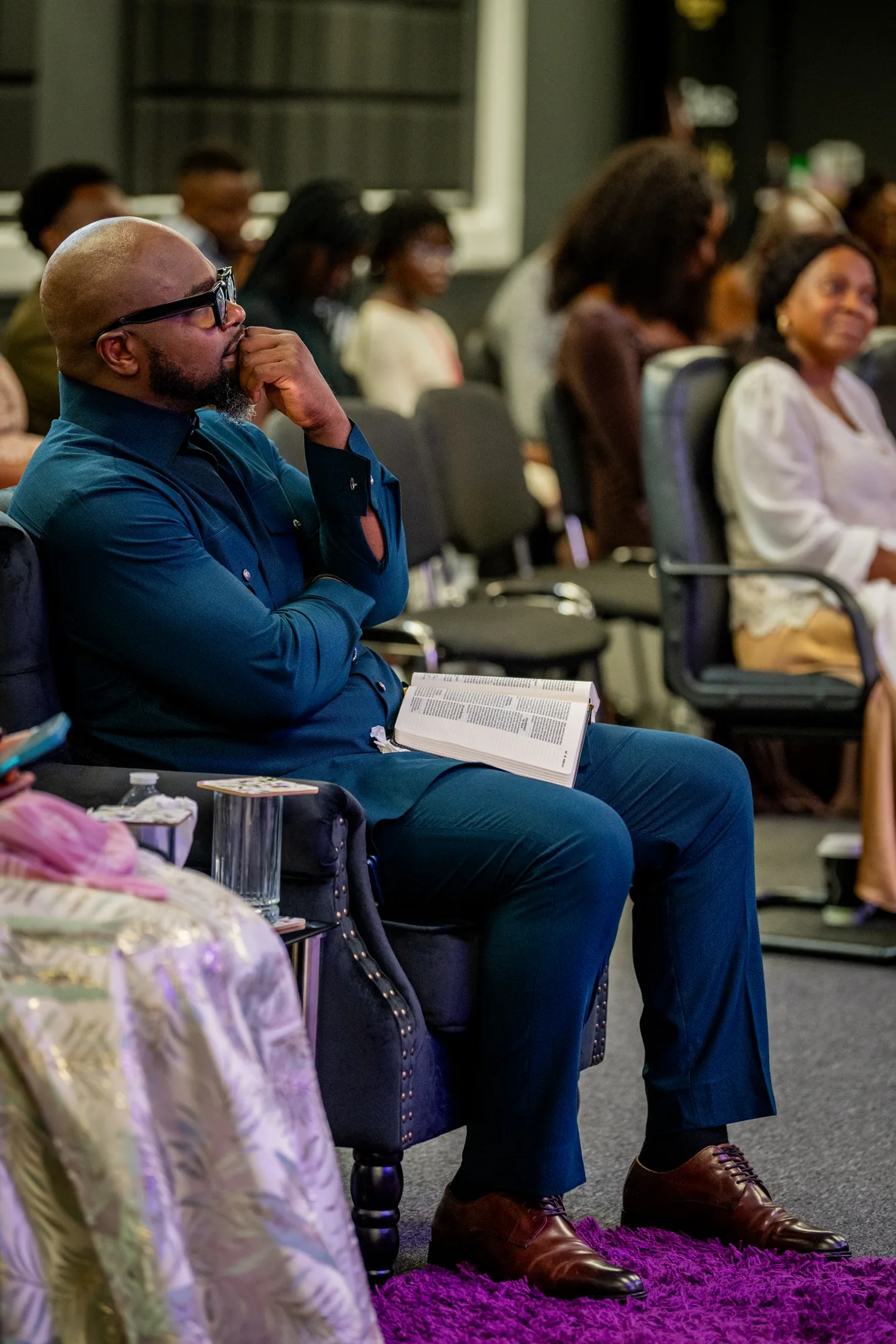 A seated congregation member listening during a church service